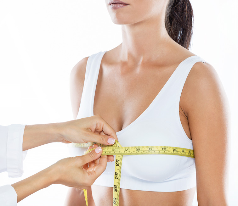 Doctor-measuring-female-patient-for-breast-augmentation